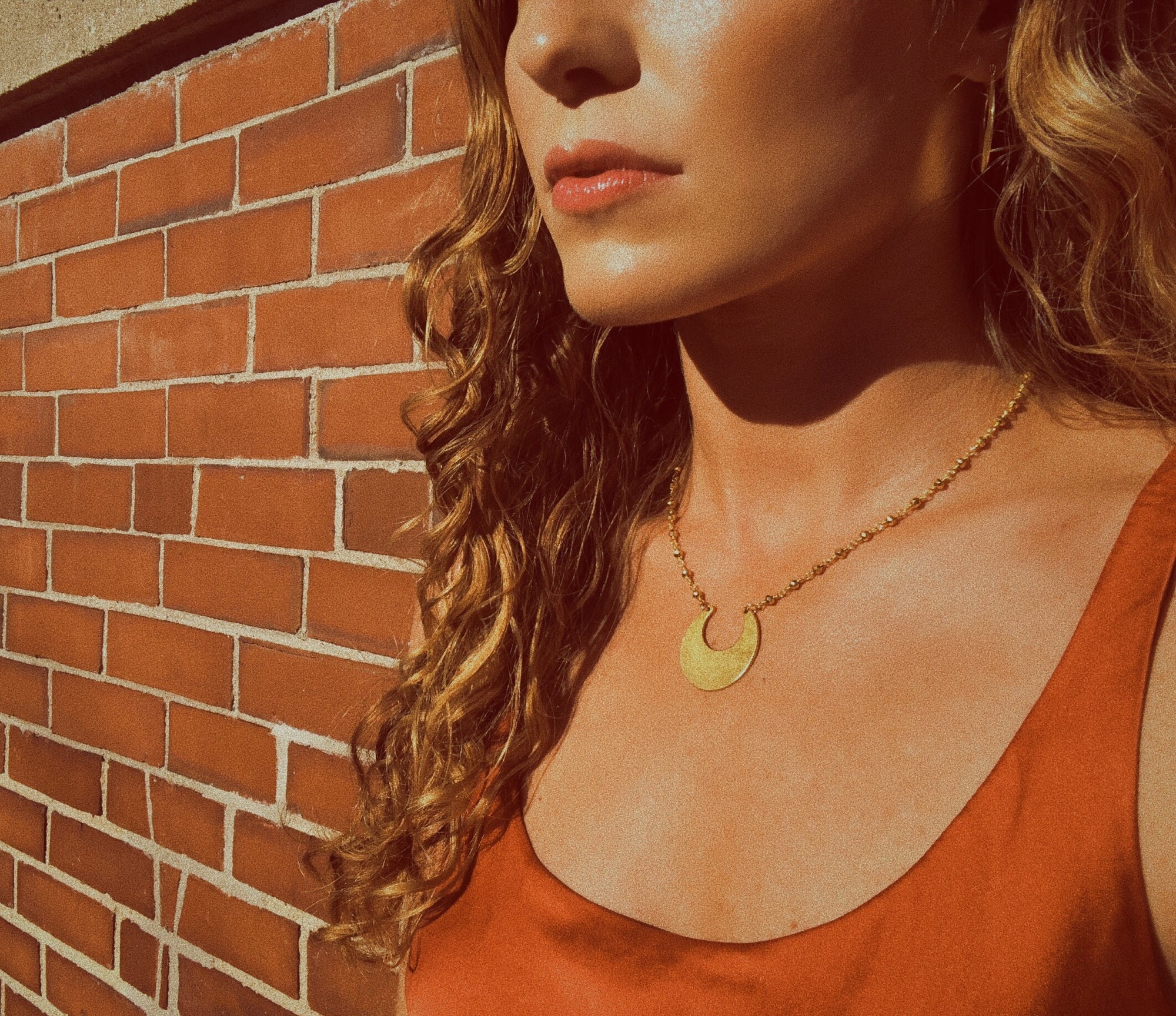 matte gold crescent moon pendant necklace - lifestyle shot - jewelry