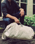 lifestyle image of the vintage navy duffle - World War 2 travel bag - French - sourced in Maine